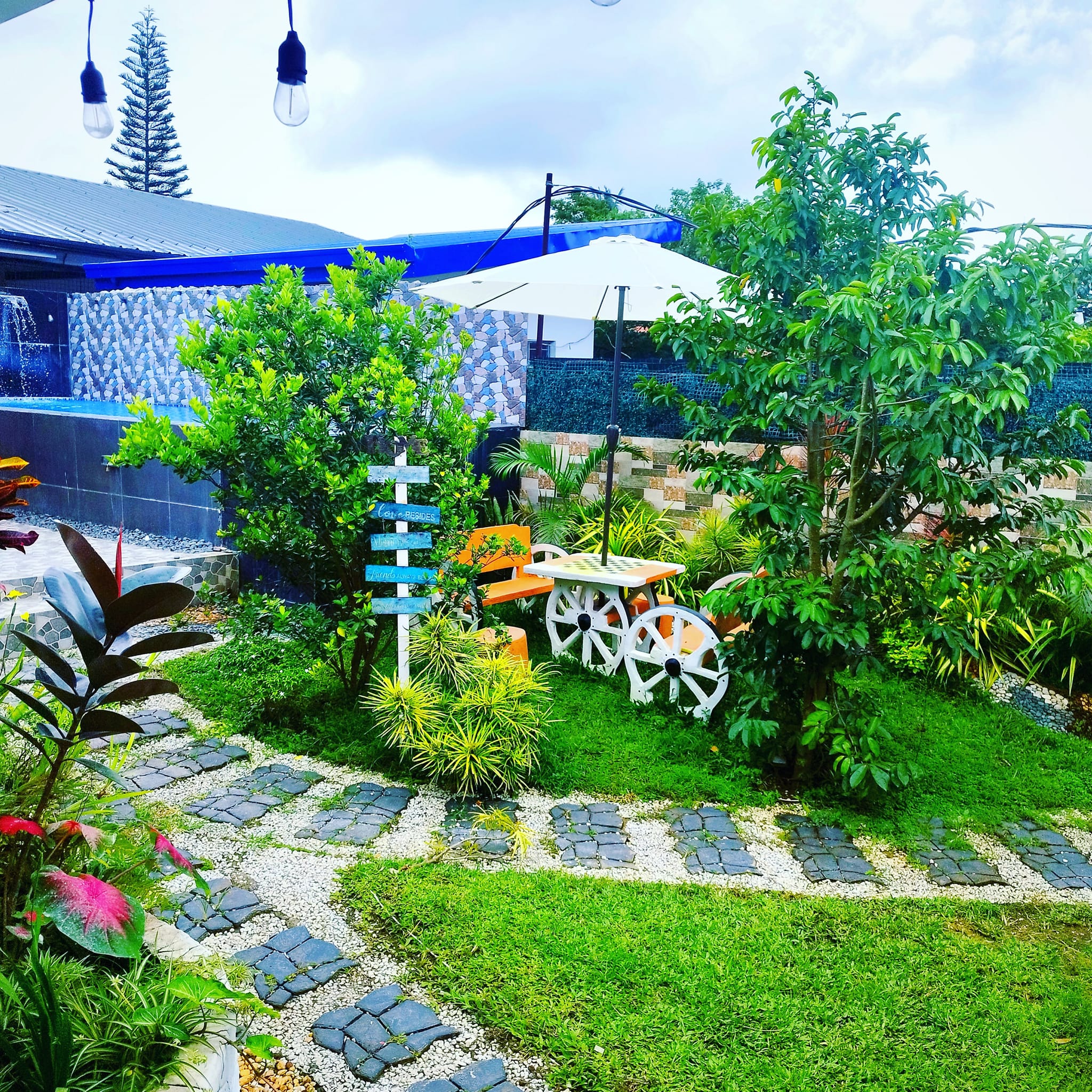 Landscaped garden with stone pathway and pool view