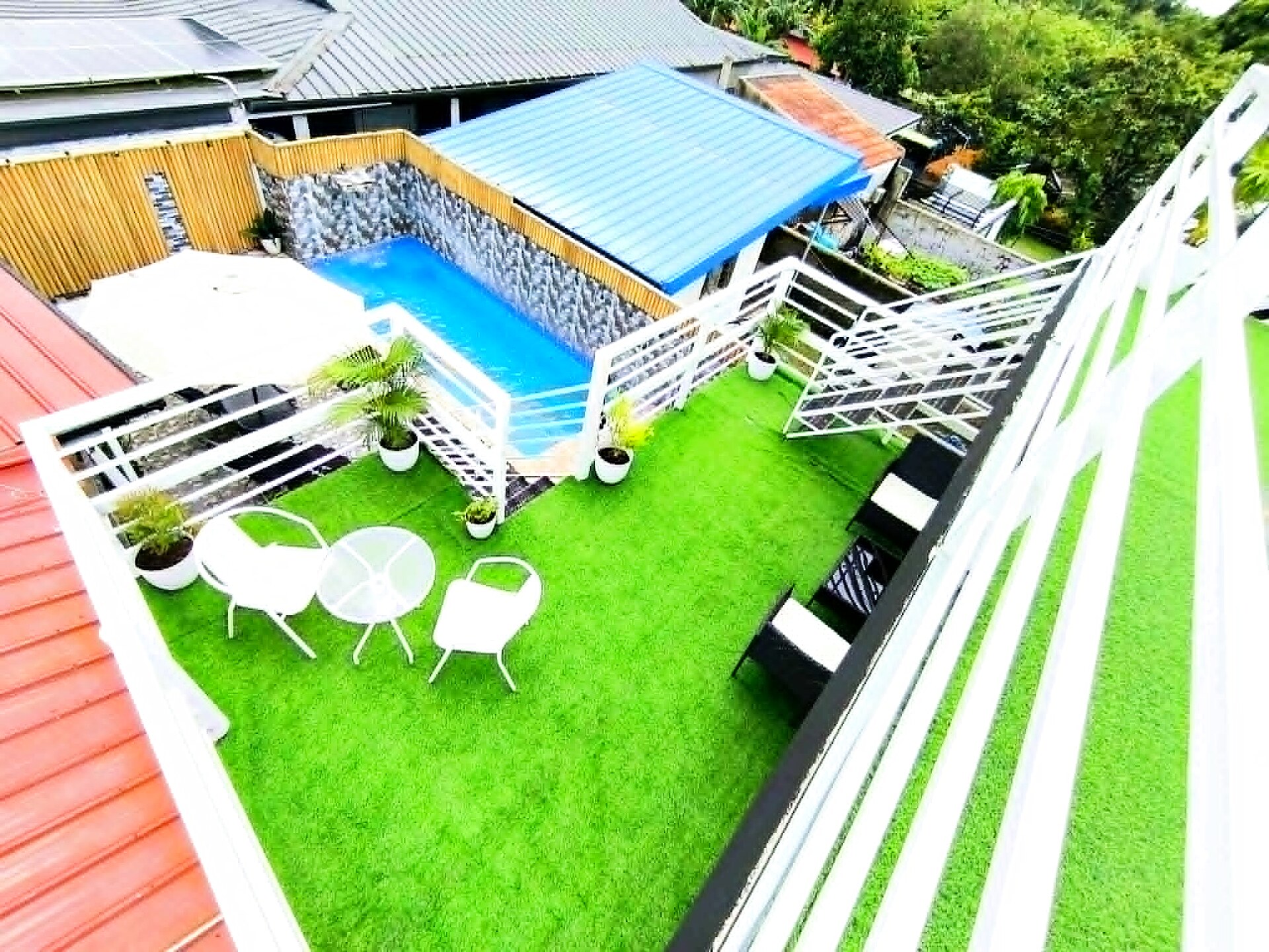Daytime aerial view of the pool deck and rooftop garden