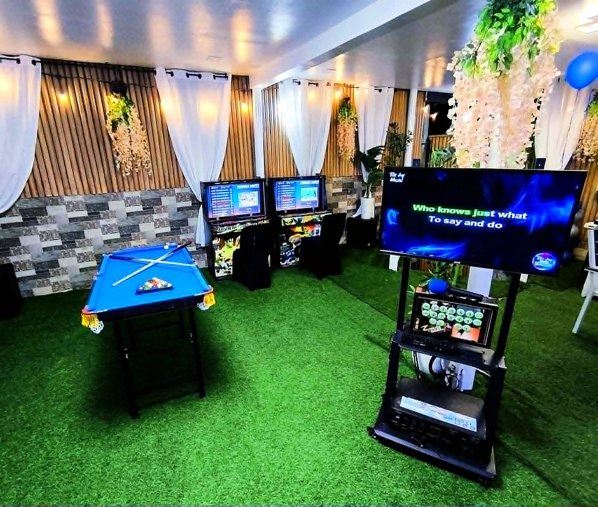 Game room with billiards table, arcade machines, and karaoke