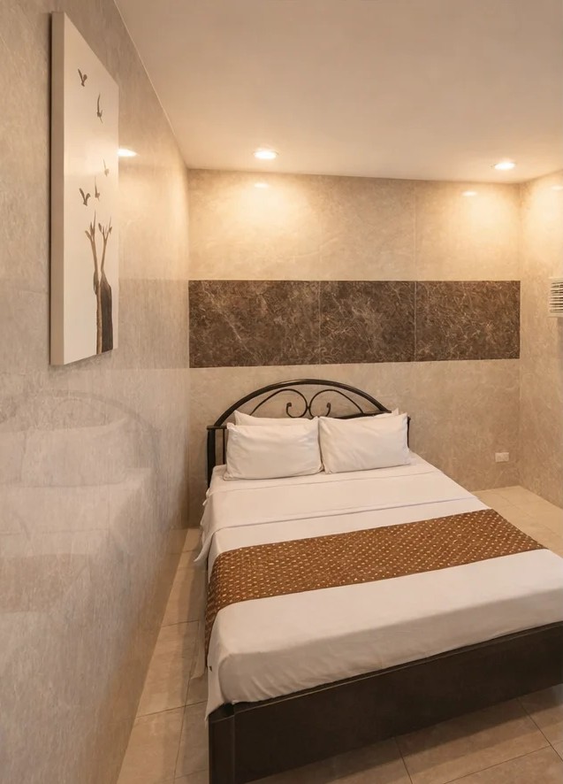 Cozy bedroom with queen bed and warm marble wall accents
